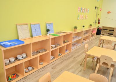 A Safari Kids classroom with bookshelves of supplies and materials.
