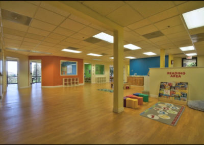 A large room with a play and reading area.