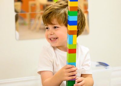 A young child playing with mega blox