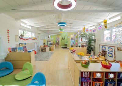 A large Safari Kid classroom with sitting areas, play areas, and assorted decorations.