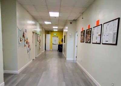 A hallway with papers and learning materials hanging on the walls.